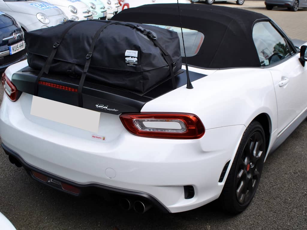 white fiat abarth 124 spider with a boot-bag vacation luggage rack fitted