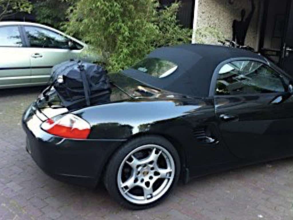 side view of porsche boxster 986 with a boot-bag boot luggage rack fitted outside a garage