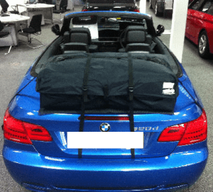 blue bmw 3 series e93 convertible with a boot-bag vacation luggage rack fitted in a bmw showroom
