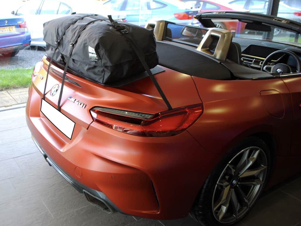 side view of a bmw z4 g29 with the roof down and a luggage rack fitted to the boot/trunk