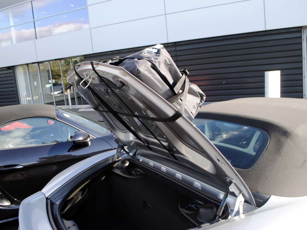 silver posche boxster 718 gts with a luggage rack fitted boot/trunk open showing how the rack attaches.