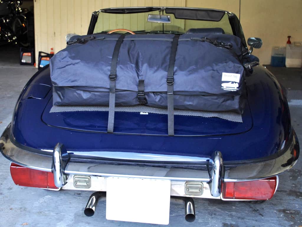 blue jaguar e type with a boot-bag vacation luggage rack fitted