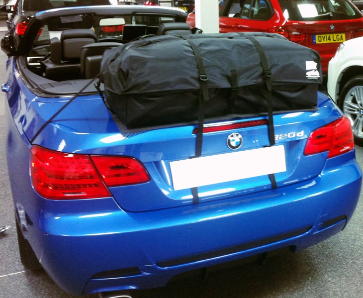 blue bmw 320d convertible with a boot-bag vacation luggage rack fitted