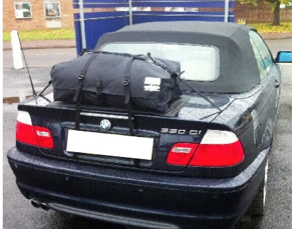 black bmw e46 convertible with a boot-bag original luggage rack fitted in the rain