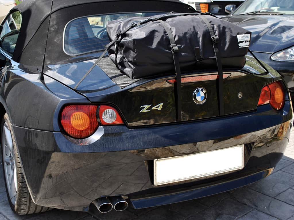 black bmw z4 e85 with a boot-bag boot rack fitted outside on a sunny day photographed from behind.