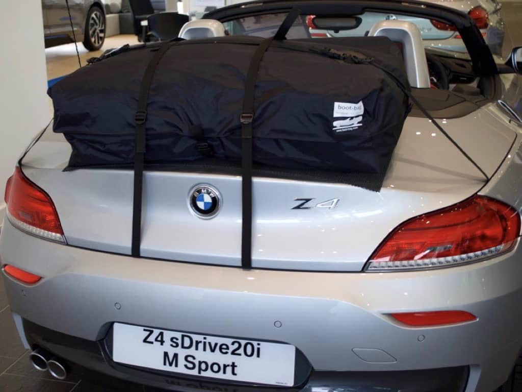 rear view of a silver bmw z4 e89 with the hood down and a bot-bag vacation trunk or boot rack fitted
