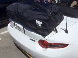 side view close up of a white mazda mx5 mk4 nd with a luggage rack fitted