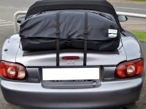 rear view of a silver dark grey mazda mk2 mx5 miata nb with a luggage rack fitted photographed from the rear
