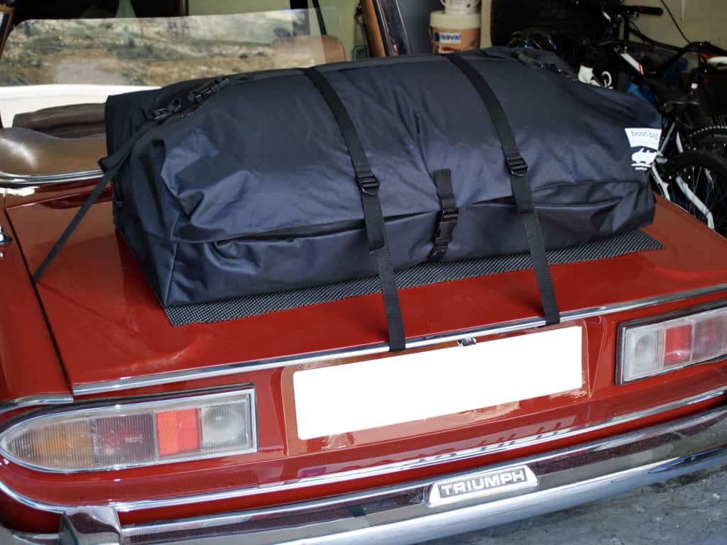 burgundy triumph stag with a boot-bag vacation luggage rack fitted 