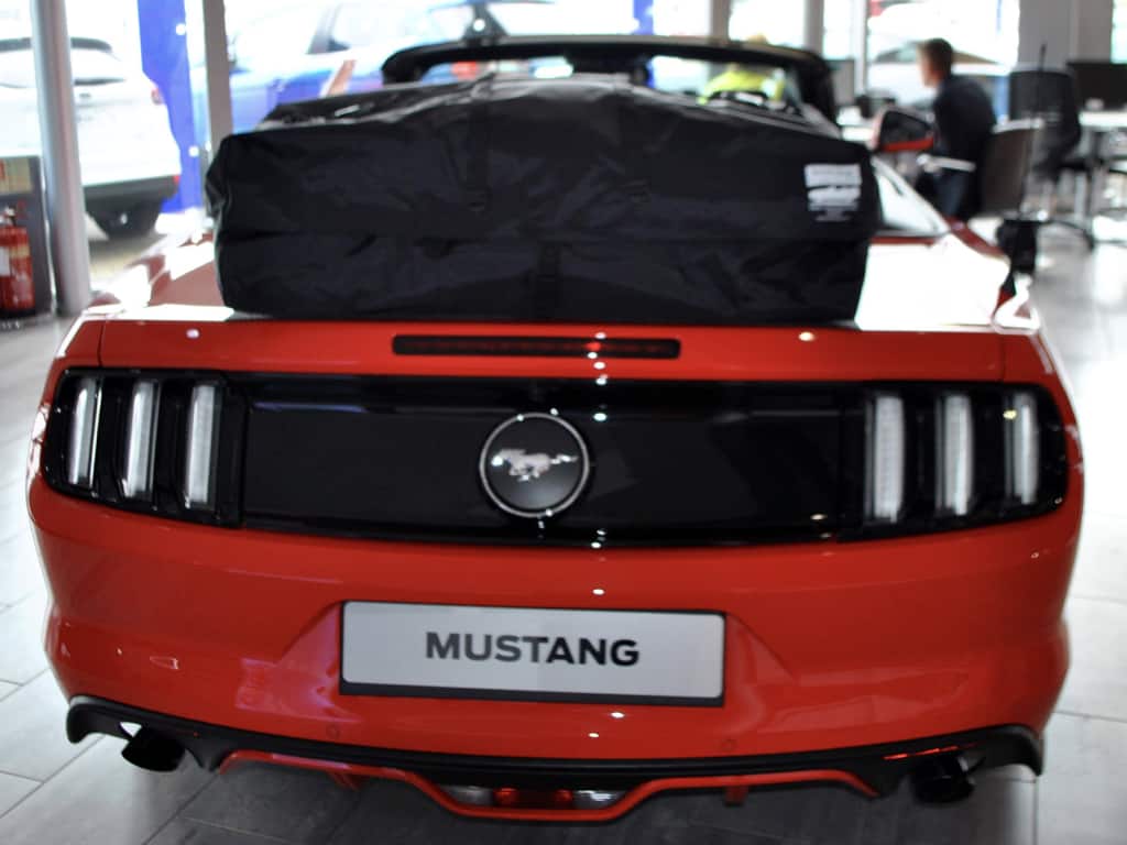 red 6th gen mustang cabriolet with a boot-bag vacation luggage rack fitted