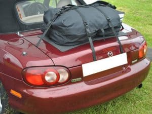 burgundy mazda mx5 mk2 hood up in a field with a boot rack fitted