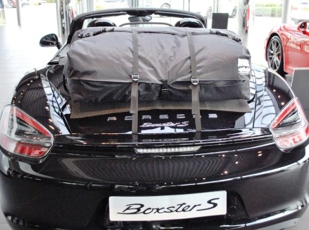 rear view of a black porsche boxster 981 with a boot-bag vacation luggage rack fitted 