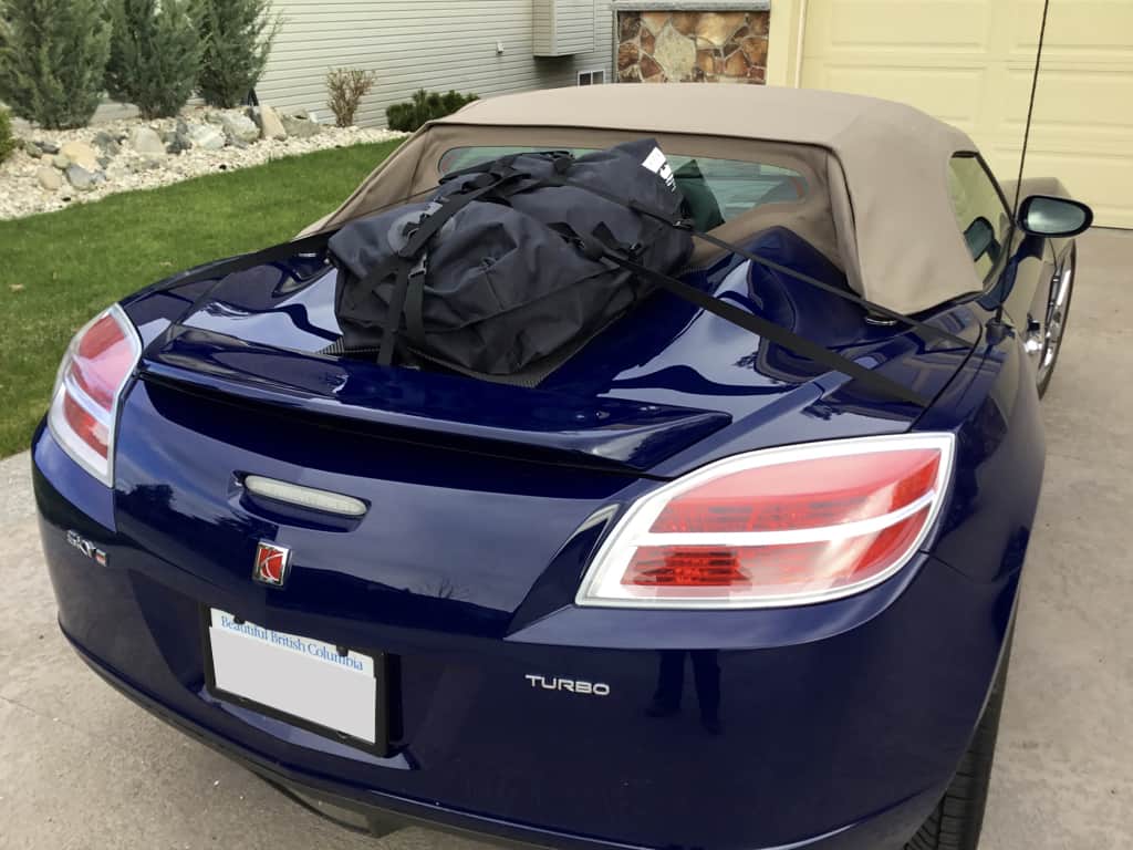 blue saturn sky on a drive way with a biege hood and a boot-bag original luggage rack fitted