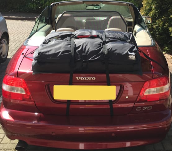 burgandy volvo c70 convertible with a boot-bag vacation luggage rack fitted