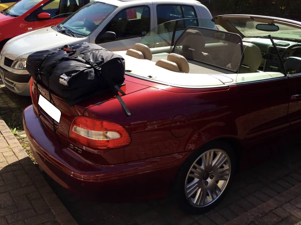 side view of a volvo c70 convertible with a boot-bag vacation luggage rack fitted