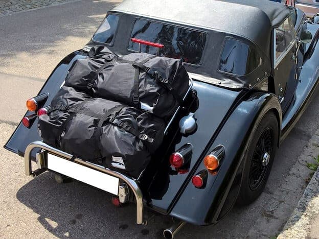black morgan convertible with two boot-bag original luggage bags fitted to the luggage rack
