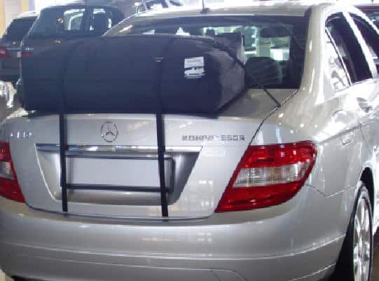 silver c200cdi mercedes benz saloon with a roof box fitted in a mercedes showroom