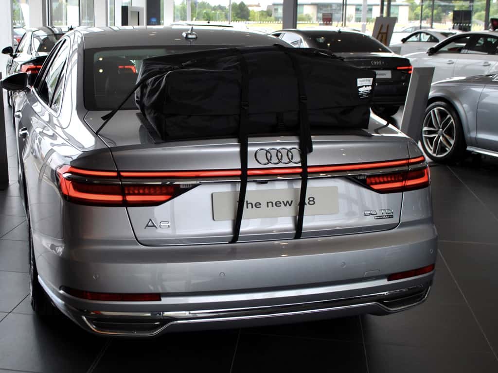 silver audi a8 saloon with a boot-bag roof box alternative fitted in an audi showroom