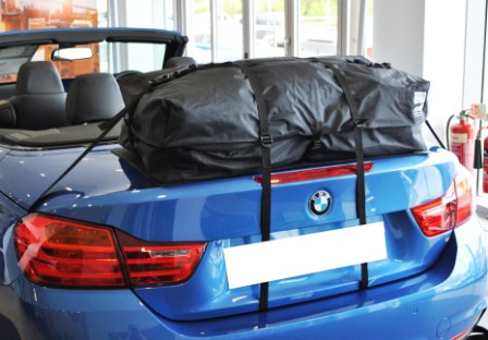 blue bmw 4 series coupe with a boot-bag roof box fitted