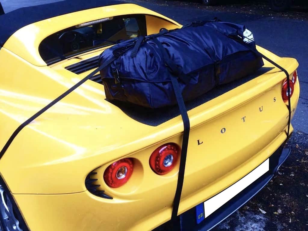 Yellow Lotus Elise with a bot-bag luggage rack fitted photographed from behind