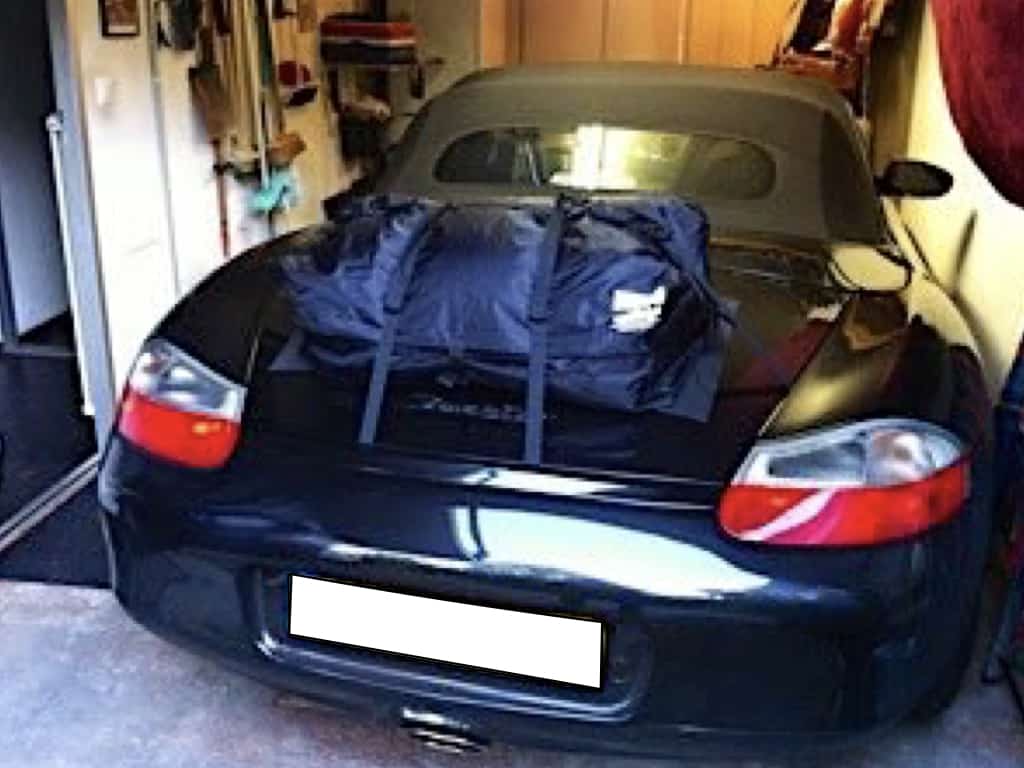 dark blue porsche boxster 986 in a garage with a boot-bag original luggage rack fitted
