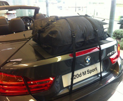 side view of a grey bmw 4 series cabriolet with a boot-bag original luggage rack fitted