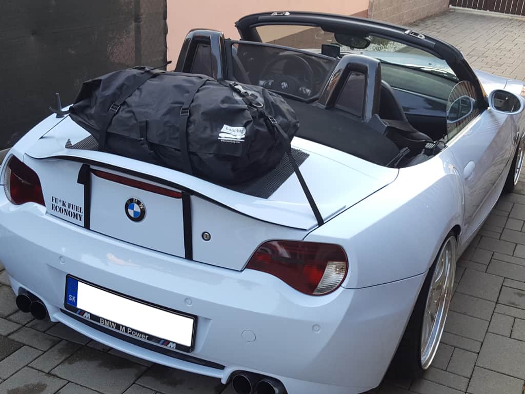 white bmw z4 e85 with the hood down and a boot-bag original boot rack fitted