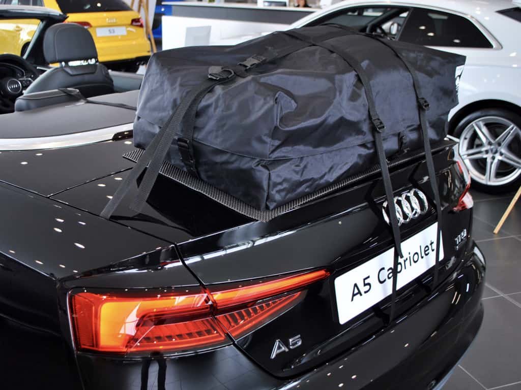 black audi a4 cabriolet with a boot-bag vacation luggage rack fitted in an audi showroom