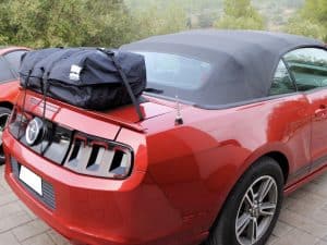 red ford mustang cabriolet with a boot-bag luggage rack fitted