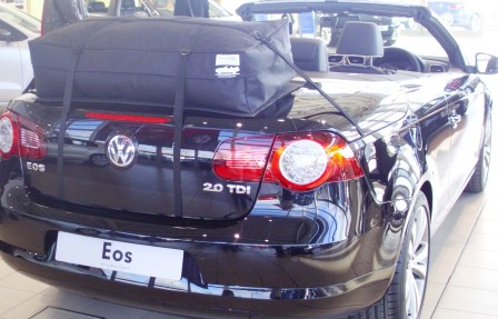 black VW Eos in a vw showroom with a boot-bag vacation luggage rack fitted