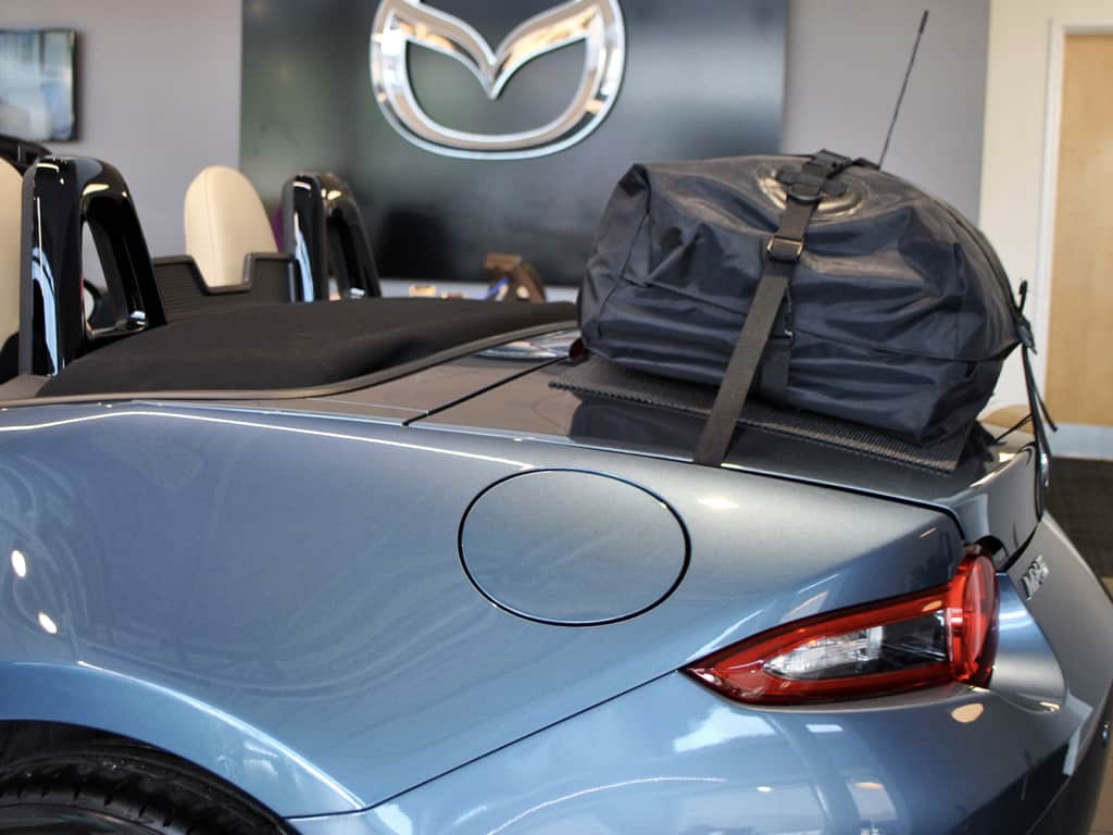 side view of a boot-bag luggage rack fitted to a blue mazda mx5 mk4 in mazda milton keynes showroom
