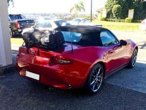 red mazda mx5 mk4 with a boot-bag luggage rack original fitted in the sunshine