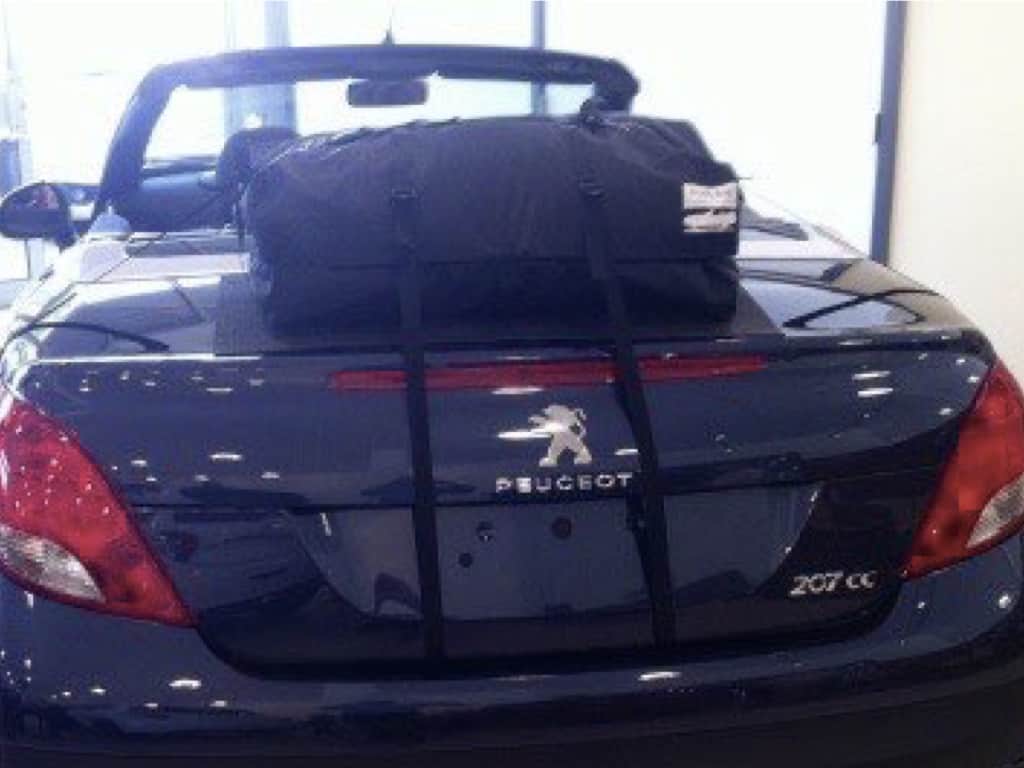 black peugeot 207cc with the roof down and a boot-bag luggage rack fitted