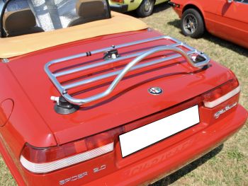 red alfa romeo spider in a field on a sunny day with a revo-rack luggage rack fitted