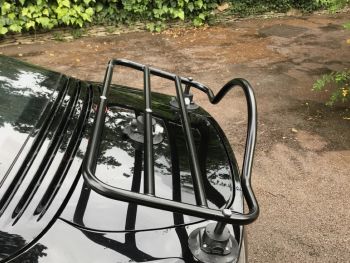 Black Alpine A110 with a luggage rack fitted photographed close