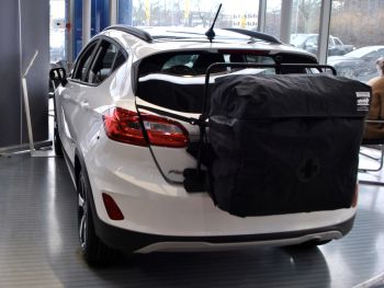 white ford fiesta with a hatchbag roof box roof rack alternative fitted to the tailgate in a ford showroom