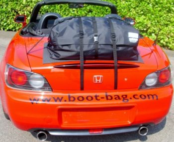 red honda s2000 beside a hedge hood down on a sunny day with a boot-bag original boot rack fitted