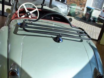 Light green Jaguar XK120 in a showroom with a revo-rack black luggage rack fitted