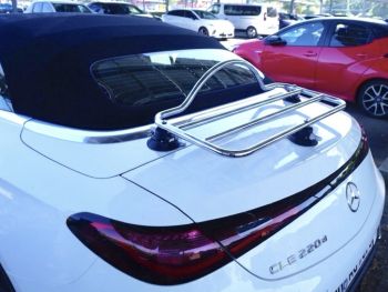 white mercedes cle convertible with a revo-rack PA chrome luggage rack fitted photographed close at the rear in a car park.