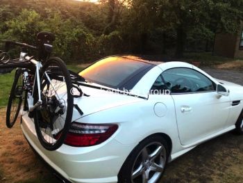 white mercedes slk r172 with a bike rack fitted carrying a mountain bike
