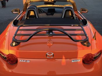 Close up of an orange mazda miata nd with a revo-rack black luggage rack fitted hood down